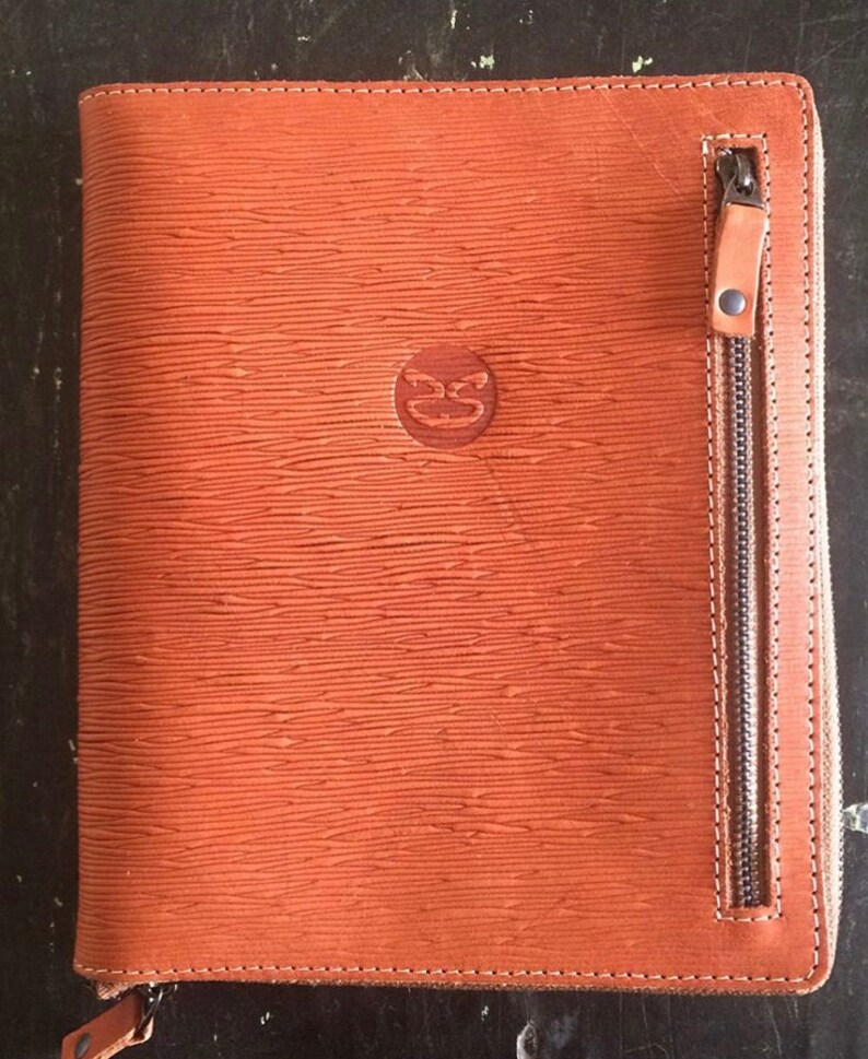 Textured leather zip organizer with embossed logo